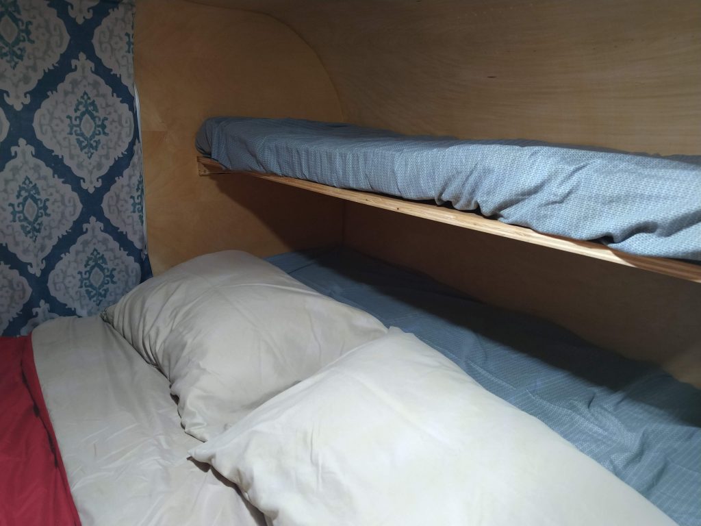 kid's bunks covered with a flat sheet